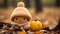 a knitted doll with a pumpkin sitting on the ground