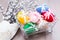 Knitted Easter eggs tied with colored ribbons in a metal basket and willow