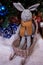 knitted elk. cute moose. toy against the background of a New Year\\\'s garland, knitted hare and elk on a Christmas tree