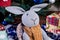 knitted elk. cute moose. toy against the background of a New Year\\\'s garland, knitted hare and elk on a Christmas tree