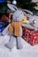 knitted elk. cute moose. toy against the background of a New Year\\\'s garland, knitted hare and elk on a Christmas tree