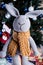 knitted elk. cute moose. toy against the background of a New Year\\\'s garland, knitted hare and elk on a Christmas tree