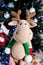 knitted elk. cute moose. toy against the background of a New Year\\\'s garland, knitted hare and elk on a Christmas tree