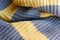 Knitted fabric large knitted yellow with grey stripes horizontally.