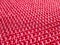 Knitted fabric of pink, crimson color close-up as a background