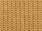 Knitted fabric texture in autumn color. Abstract background. Close-up