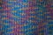 Knitted fabric texture. Closeup view of multicolored fabric jersey. Multicolor abstract background and texture for designers. Colo