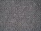 Knitted fabric texture. Gray. Simple knitting with front and back loops. Knitting on the knitting needles. Horizontal lines