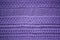 Knitted fabric violet background close up