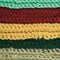 Knitted fine wool garment colorful stripes background natural texture, yellow, beige, claret, blue, green scarf macro closeup