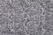 Knitted grey fabric texture with a relief pattern