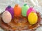 Knitted hats for Easter eggs on a wooden plate