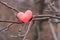 Knitted heart on a tree branch. Spring soon. The approaching holiday on February 14 is Valentine`s Day. Love symbol