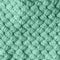 Knitted homemade Woolen textured scarf toned to neo mint color. Color of the year 2020 concept