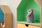 Knitted mouse on house shaped shelf indoors. Baby room interior design