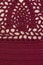 Knitted openwork pattern, burgundy color. Textured fabric