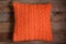 Knitted orange cushion