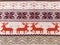 Knitted patterns with snowflakes, deer, flowers, broken stripes. Orange, red brown, white, beige woolen threads. Folk art. Warm