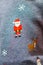 Knitted Santa claus, reindeer, snow and snowman on gray sweater