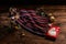 Knitted scarf with black, white and red stripes, Christmas decorations and a metal box with a picture of Santa Claus on a wooden