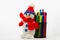 Knitted snowman, as the main symbol of winter, rests on cup with multi-colored markers on a light background