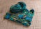knitted sock knitted with green striped yarn  wooden knitting needles and a ball of wool yarn  handicrafts as a hobby  knitting