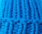 Knitted texture. A sample of knitting from wool. Color of the year. Beautiful blue background for design