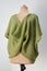 Knitted vest in moss green color on mannequin. spring seasonal clothing