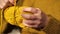 Knitting concept.Hands winding a woolen skein yellow yarn close-up. Hobby and needlework concept. Knitting warm clothes