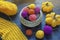 Knitting concept. Yellow knitted pumpkins, colorful balls of wool and unfinished knitting
