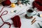 Knitting needles, coffee and candles, fir sprigs and Christmas lights on white background.
