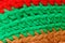 Knitting red green brown macro texture background