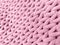 Knitting from thick soft yarn of pink color. Textile background.