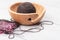 Knitting with a wool yarn ball in a wooden bowl on a white oak d