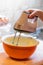 A knob of butter and sugar icing mix in a metal mixing bowl ready to be prepared into a cake recipe. Sweet deserts being prepared