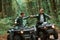 Knocking fists, gesture. Two male atv riders is in the forest together