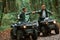 Knocking fists, gesture. Two male atv riders is in the forest together