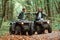 Knocking fists, gesture. Two male atv riders is in the forest together