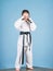 Knockout. energy and activity for kids. little girl in gi sportswear. small girl in martial arts uniform. practicing