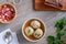 Knodel or canederli  soup in a bowl with speck and parsley, top view