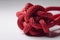 Knot of red nylon rope closeup isolated on white background. Generative AI