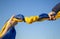 Knot of a stretched blue and yellow Ukrainian flag against the sky