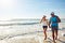 We know just how to have fun. a happy young couple taking a walk on the beach.