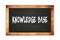 KNOWLEDGE  BASE text written on wooden frame school blackboard