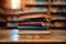 Knowledge hub Stacks of books, wooden table, blurred bookshelf environment