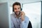 He knows the ins and outs of the business. a young corporate businessman using a headset in an office.