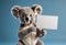 Koala holding a blank sign on blue background. Generative AI