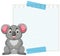 A koala sitting beside a blank grid notepad