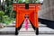 Kobe,Japan,15 July 2019,Pink kimono teenage girl stands in Torii arranged parallel to Ikuta shrine