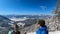 Kobesnock - Couple with scenic view of snow capped mountain peak Dobratsch, Julian Alps and the Karawanks, Austria